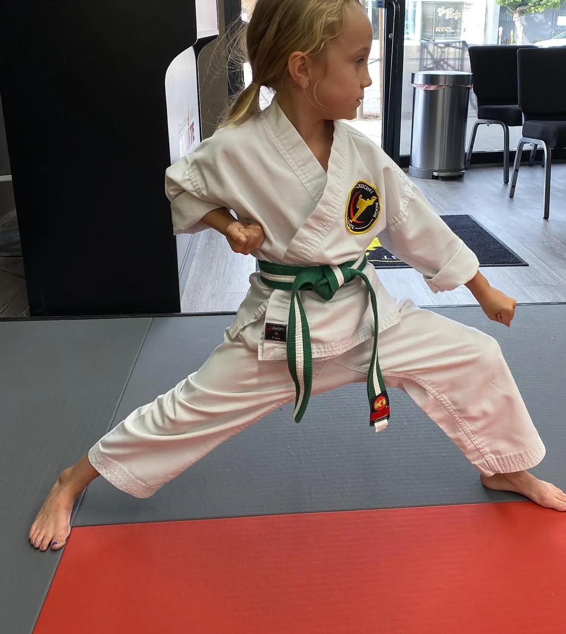 A student holding a front stance during class.